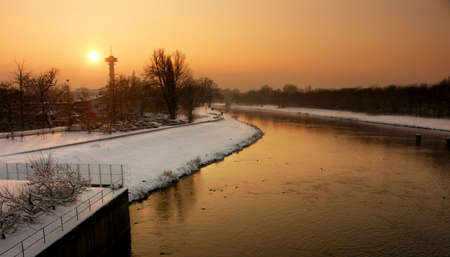 sunset above river in winterの写真素材
