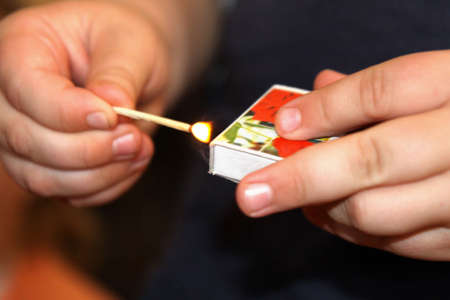 scratch matches in child's handの写真素材