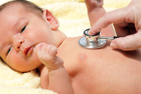 Stethoscope listening to a babyの写真素材