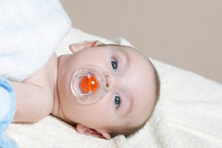 Newborn - close-up focus baby boy with blue pacifier