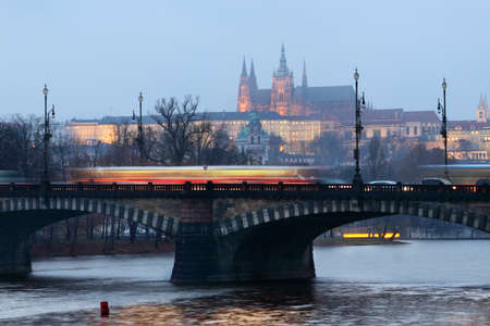 The magnificent Prague Castle at early evening along the River Vltava with bridge and ridden tramwayのeditorial素材