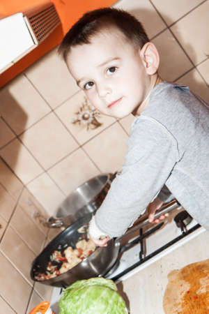 wounded in the left hand with bandage boy at shot in home kitchenの写真素材