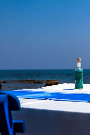 Tables with chairs in traditional Greek tavern in Kolympia town on coast of Rhodes island, Greece.の写真素材