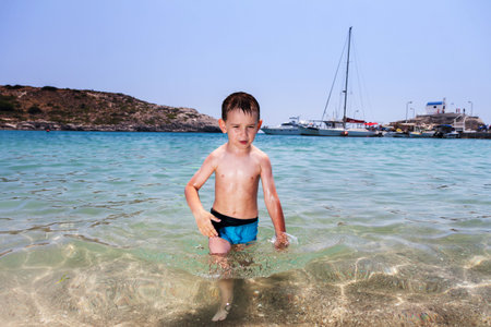 little boy in blue sea