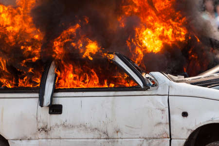 burning and then extinguish an old white car - Exercise firefightersの写真素材