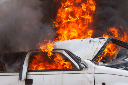 burning and then extinguish an old white car - Exercise firefightersの写真素材