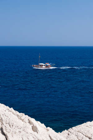 Kolymbia beach with the rocky coast in Greece. Motorboat and speed  in blue sea.の写真素材