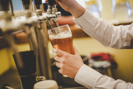 A hand holding a glass of wine. High quality photoの写真素材