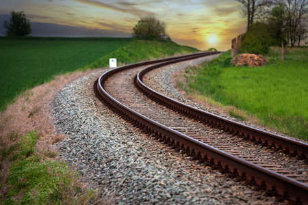 A large long train on a train track with trees in the backgroundundefinedの写真素材