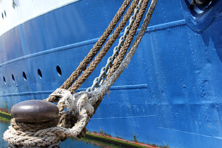 moored old ship with chain and ropes in the port