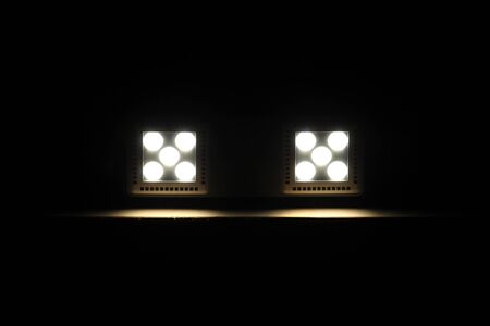 Two LED lights on the dark wooden ceiling, technology backgroundの写真素材