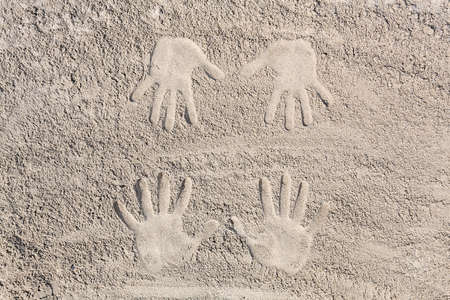 four hands footprint in the sand at the beachの写真素材
