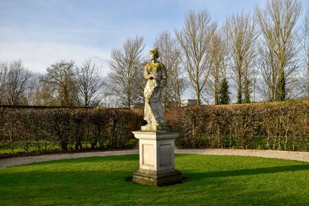 a sculpture of a woman in a european gardenの写真素材