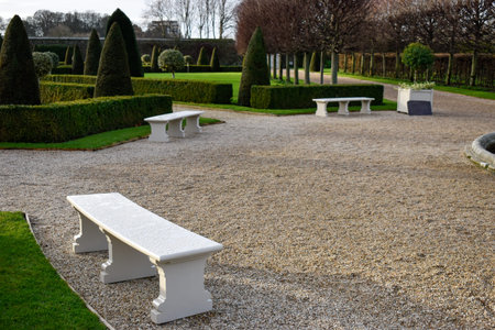 Benches in a european garden on a clear winters dayの写真素材
