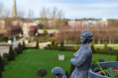 a sculpture of a woman in a european gardenの写真素材