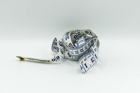 Health and fitness fat loss measuring tape isolated on white backgroundの写真素材