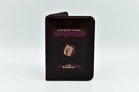Irish European Union Travel Passport in a leather cover isolated on white backgroundの写真素材