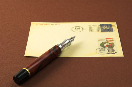 vintage postcard and pen in brown old fabric