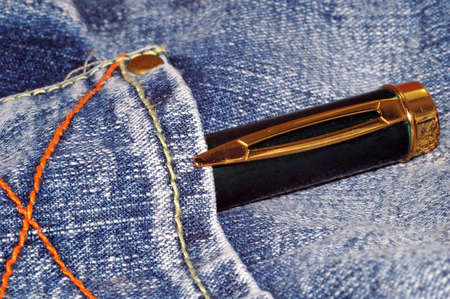 golden pen in back pocket of jeanの写真素材
