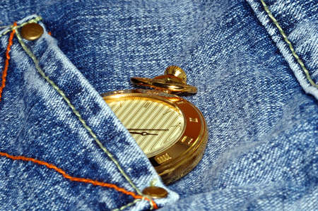 golden pocket watch in back pocket of jeanの写真素材