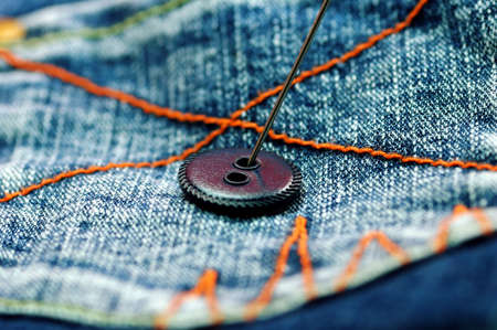 needle and button in back pocket of jeanの写真素材
