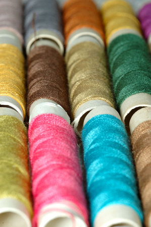 macro shot with  assorted colors reels of thread