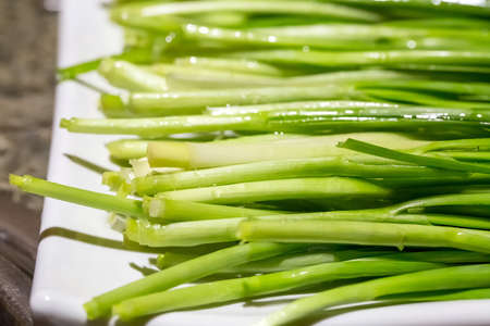 Leek is placed on small dish marketplace, bunchの写真素材
