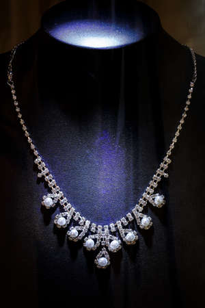 Gold and diamond necklaces isolated on black backgroundの写真素材