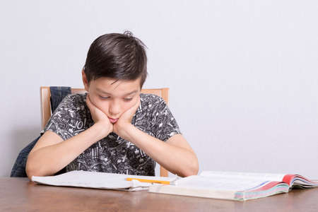 Young Boy Doing His Homeworkの写真素材