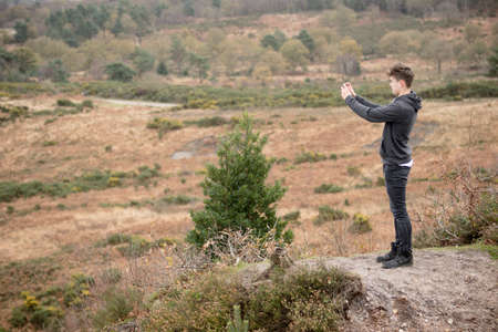 Teenage Boy Taking A Photo With His Phoneの写真素材
