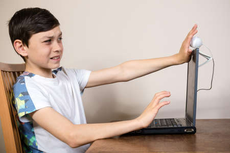 Young boy blocking a webcam