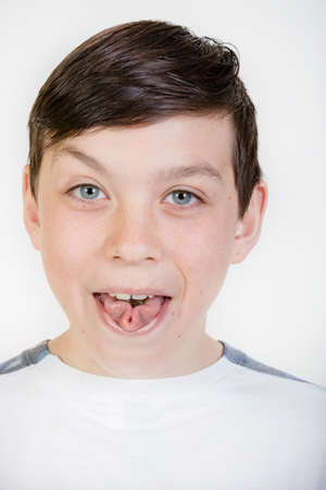 Young boy rolling his tongueの写真素材