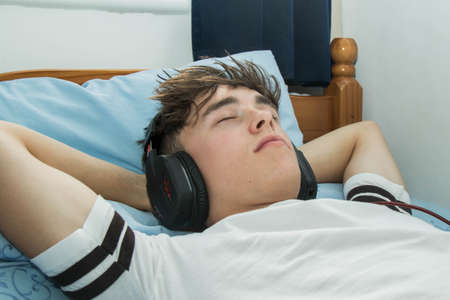 Teenage boy listening to musicの写真素材