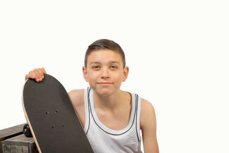 Young teenage caucasian boy with his skateboardの写真素材