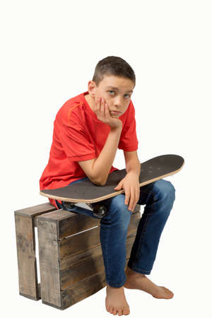 Young teenage caucasian boy with his skateboardの写真素材