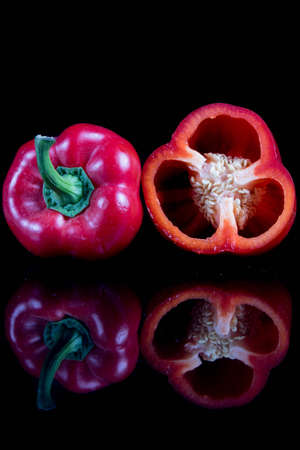 A single sweet bell pepper cut in halfの写真素材