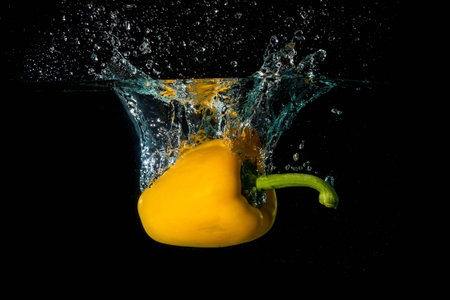 Yellow Bell Sweet Pepper Droped Into Waterの写真素材