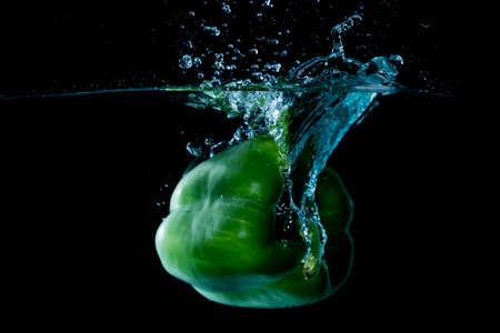 Green Bell Sweet Pepper Droped Into Waterの写真素材