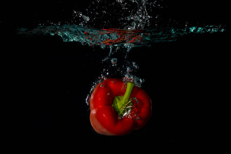 Red Bell Sweet Pepper Droped Into Water