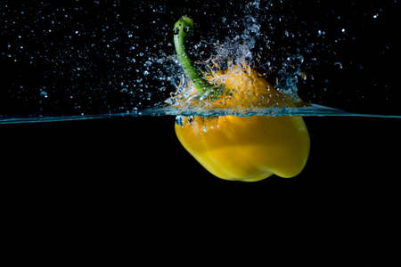 Yellow Bell Sweet Pepper Droped Into Waterの写真素材