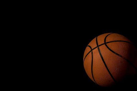 A single basketball isolated on a black backgroundの写真素材