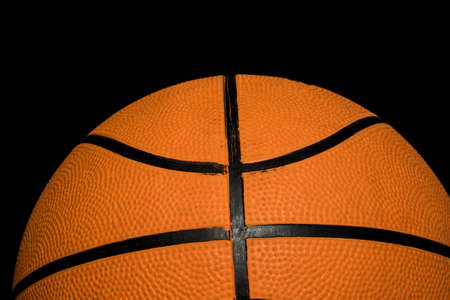 A single basketball isolated on a black backgroundの写真素材