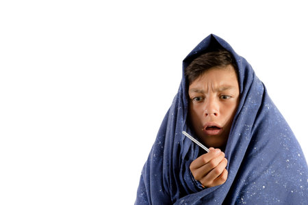 Unwell young teenage boy isolated against white background