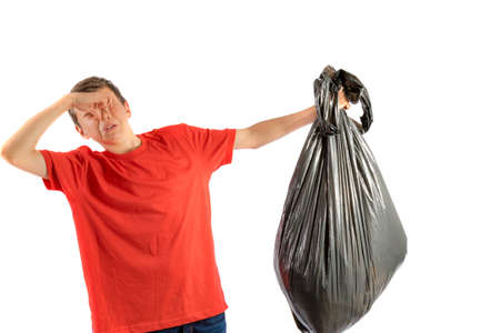 Young teenage boy isolated on a white background with smelly rubbishの写真素材