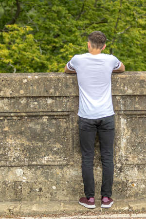 Teenage boy in a park on a warm summers dayの写真素材