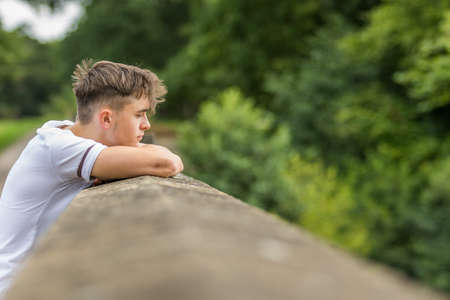 Teenage boy in a park on a warm summers dayの写真素材