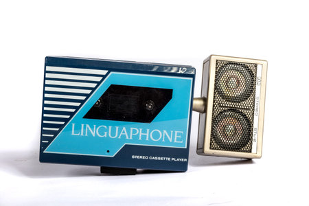 Retro personal portable cassette player with speakers isolated on a white background