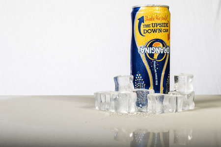 London, 24th October 2017:- A can of chilled Orangina with ice against a white background