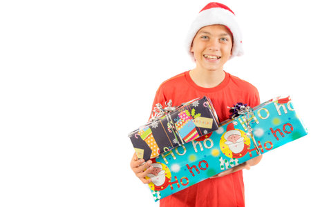 Young teenage boy holding  Christmas gifts, isolated on white background
