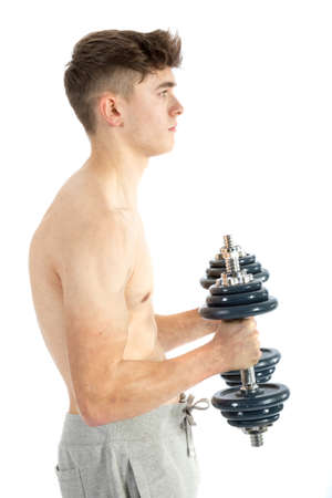 18 year old teenage boy using dumbbellsの写真素材